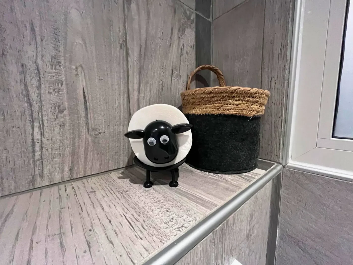 Porte-papier toilette original en forme de mouton noir dans la salle de bain de l'Hôtel La Rencluse.
