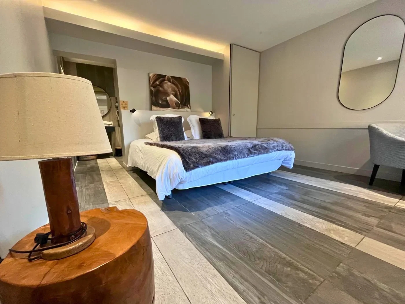 Chambre double PMR n°25 avec grand lit King-size, luminaire en bois massif et tableau d'ours polaire.